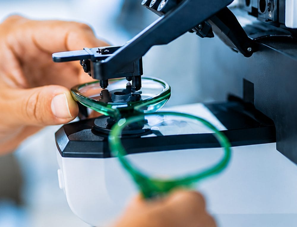 A Direct Sight technician checking a finished pair of lenses on a focimeter
